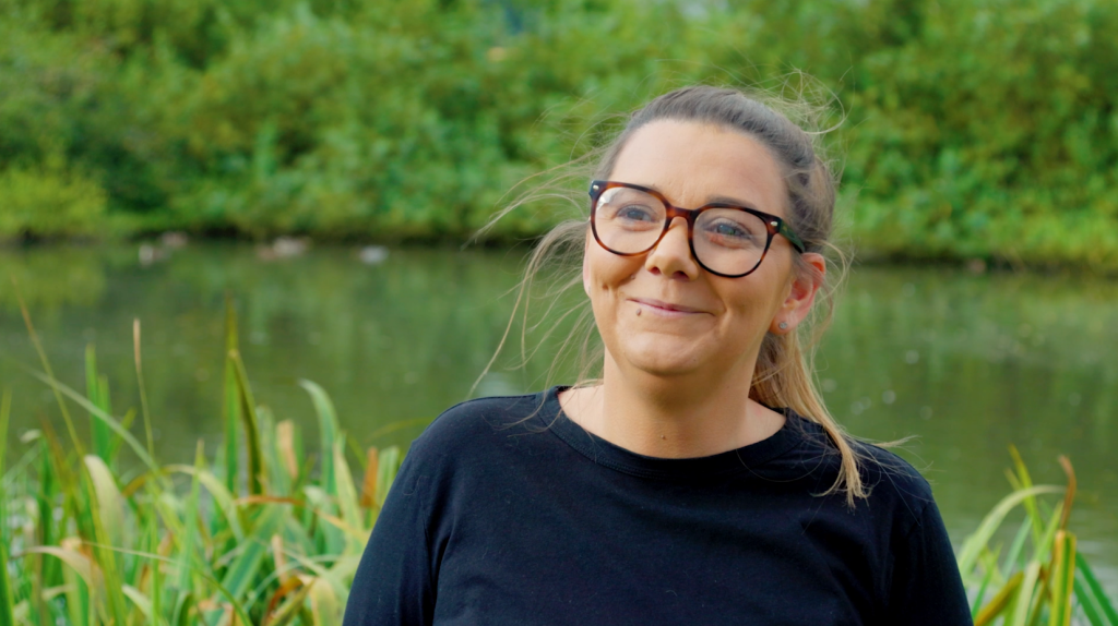 Kim Oglesby with a pond in the background