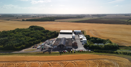 Birds eye view of the Harvest production facility, surrounded by fields and woodland.